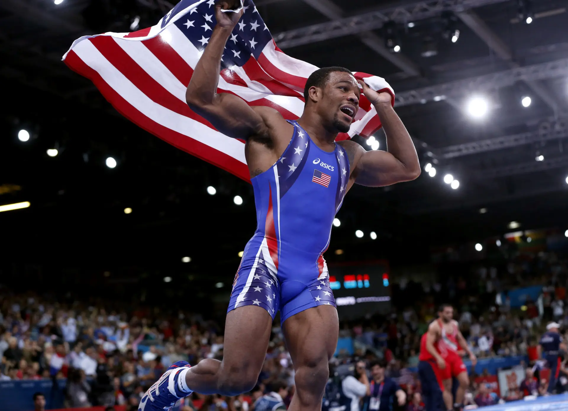 Wrestler celebrating a victory with the American flag